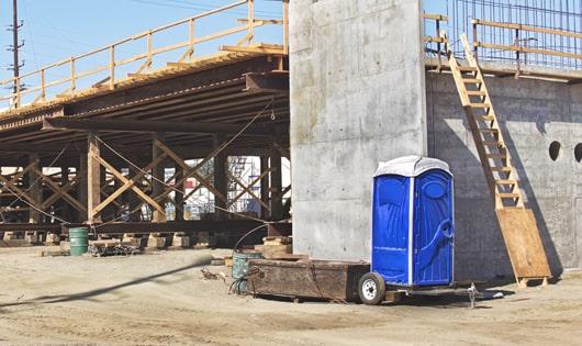 the convenience of on-site restrooms a construction site lined with porta potties